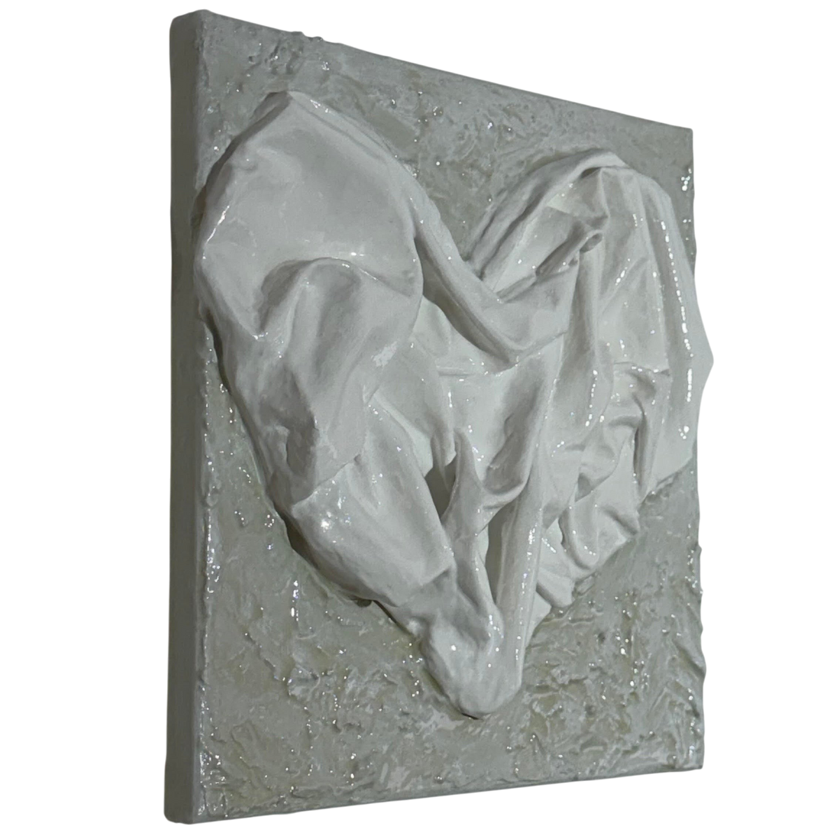 Bianco Terra AFFETTO No. 02 textile heart wall art with glossy fabric folds on a distressed matte plaster background.