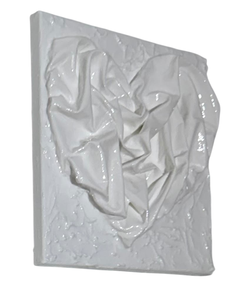 Bianco Terra AFFETTO No. 03 textile heart wall art with glossy fabric folds on a distressed matte plaster background.
